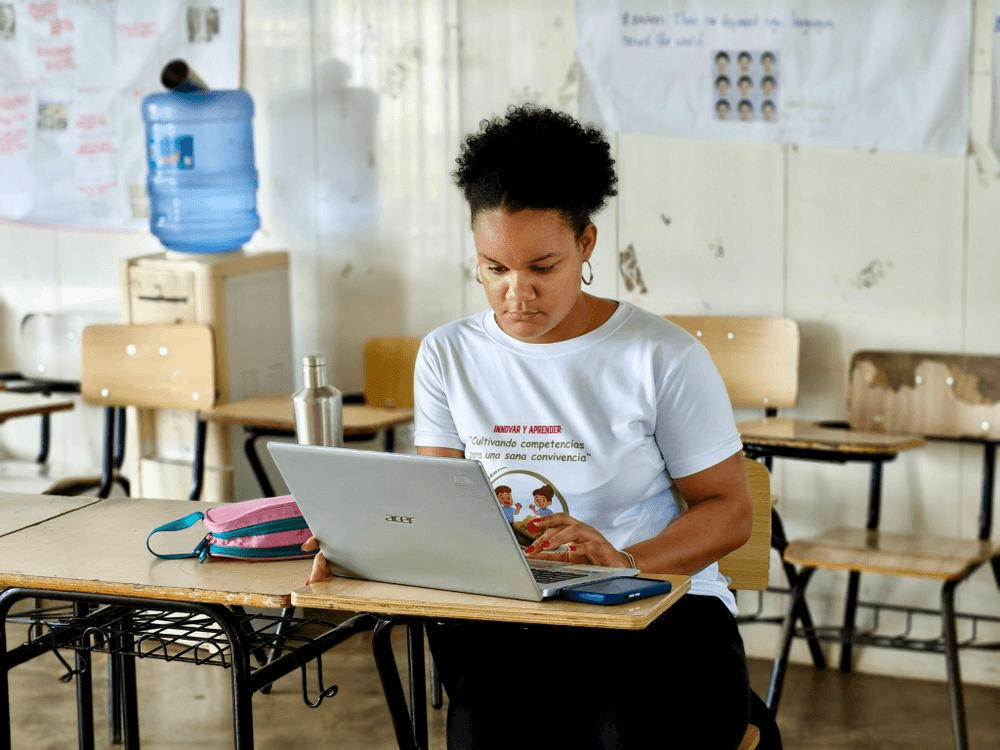 Student working on a laptop at a classroom desk
